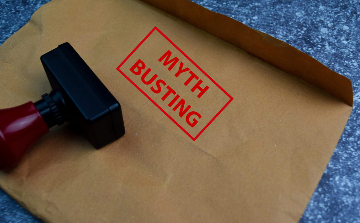 Myth Busting text on document above brown isolated on Office Desk