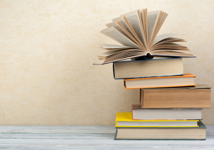 Stack of colorful books. Education background. Back to school. Book, hardback colorful books on wooden table. Education business concept. Copy space for text.