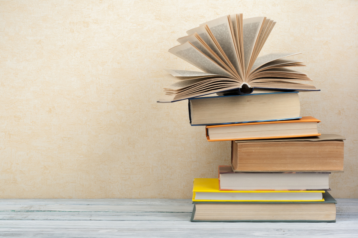 Stack of colorful books. Education background. Back to school. Book, hardback colorful books on wooden table. Education business concept. Copy space for text.