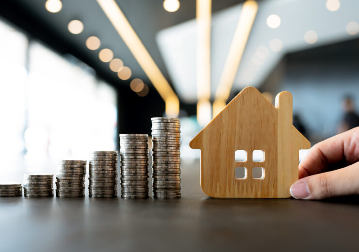 Wood house and row of coin money on wood table and , selective focus, Planning to buy property. Choose what's the best. A symbol for construction ,ecology, loan concepts.
