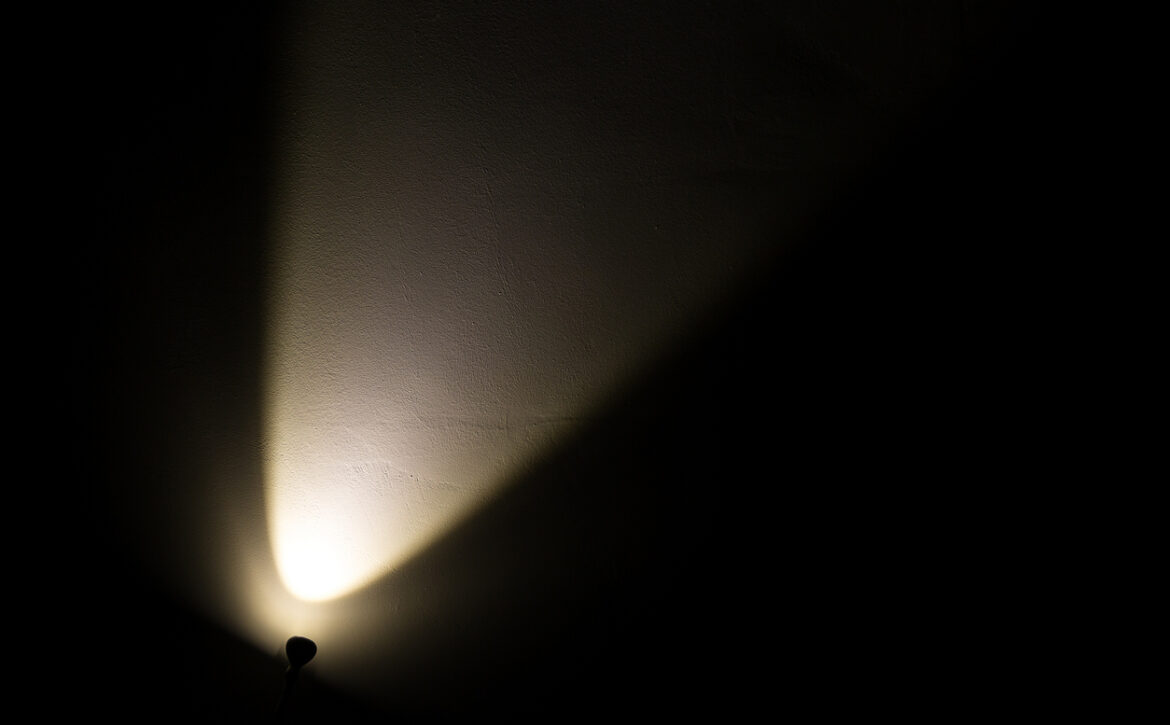 Dark Wall Illuminated from the Left Corner Spotlight Lamp