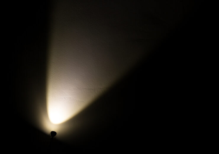 Dark Wall Illuminated from the Left Corner Spotlight Lamp