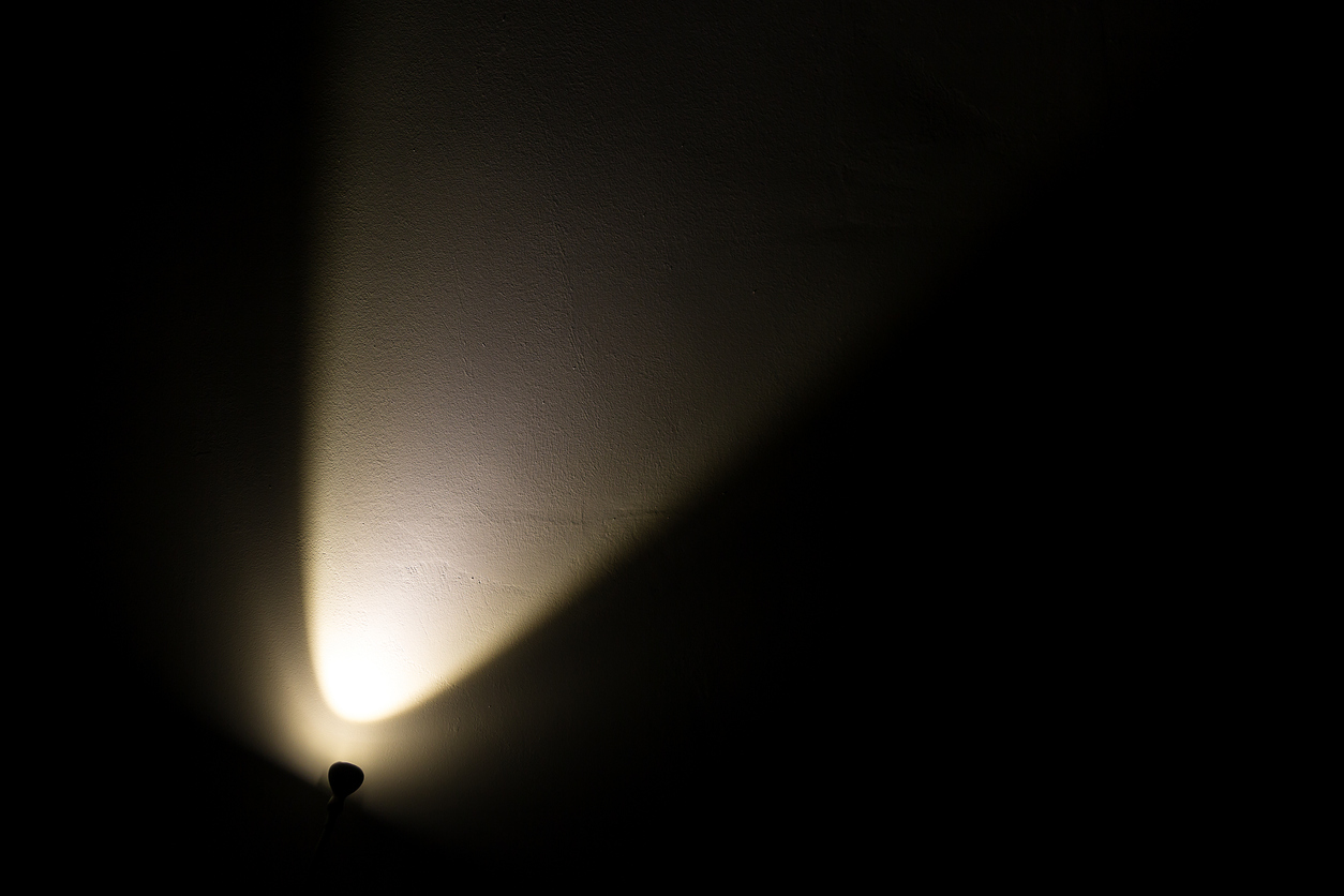 Dark Wall Illuminated from the Left Corner Spotlight Lamp