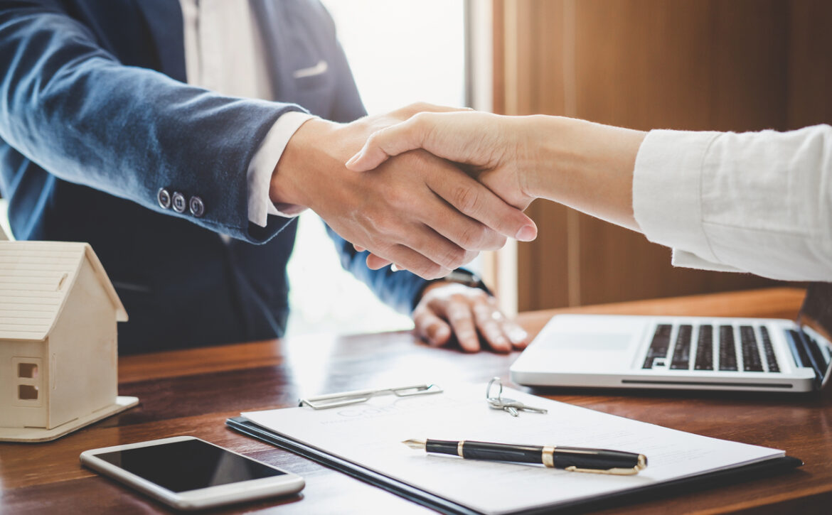 Real estate agent and customers shaking hands together celebrating finished contract after about home insurance and investment loan, handshake and successful deal