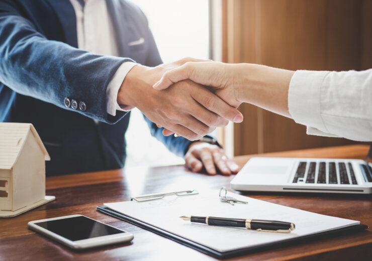 Real estate agent and customers shaking hands together celebrating finished contract after about home insurance and investment loan, handshake and successful deal