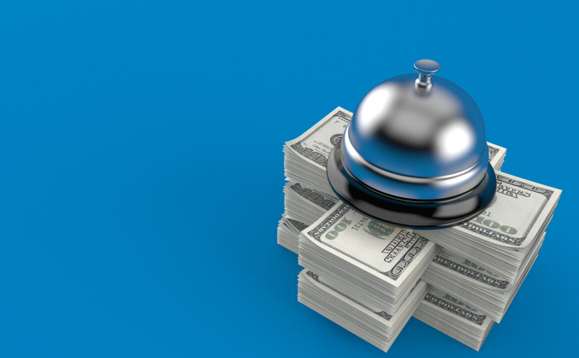 Hotel bell on stack of money