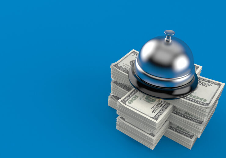 Hotel bell on stack of money
