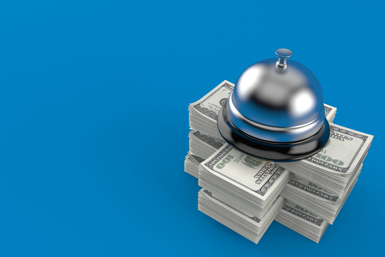 Hotel bell on stack of money