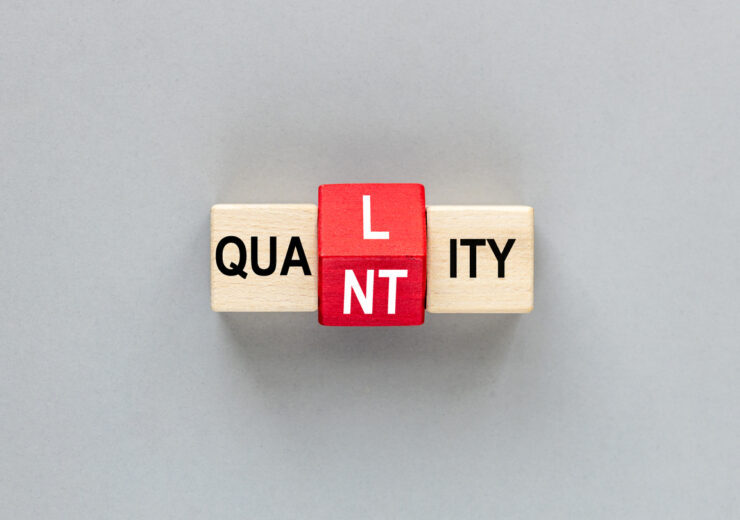 QUALITY and QUANTITY concept. letters on wooden blocks changes the word quality to quantity. Business concept. beautiful gray background. flat lay, copy space