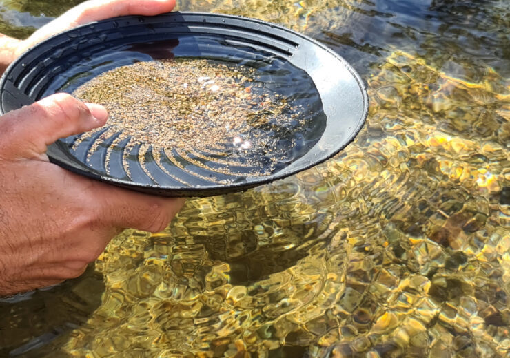 Close-up of a man's hands holding a gold panning prospecting pan