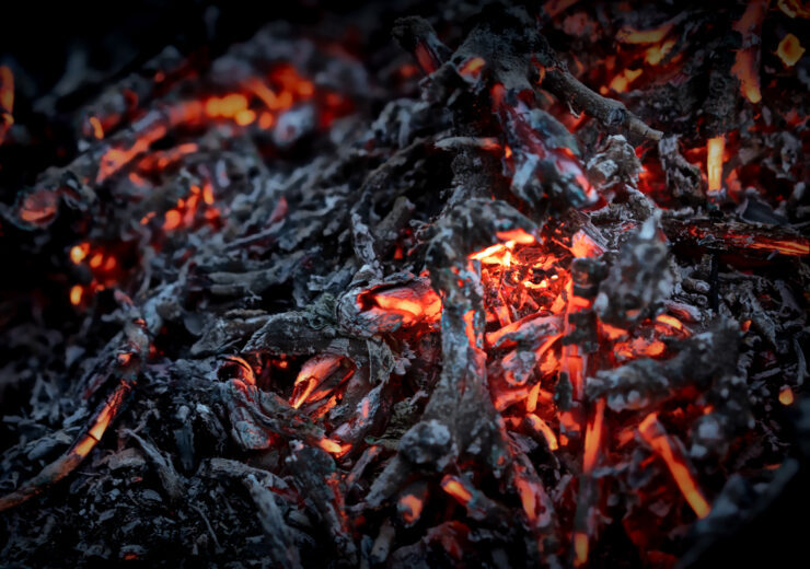 Glowing embers in a darkened space create a mesmerizing and warm ambiance during a quiet evening