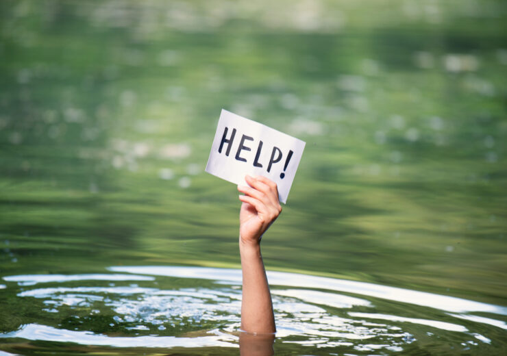 Drowning victim, hand with help sign, danger of swimming in lake or river, struggle to survive, failure and rescue in waters