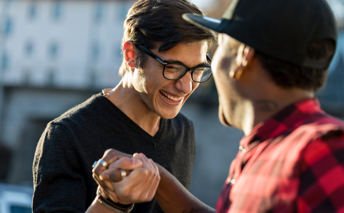 good friends joking about their secret handshake