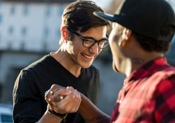 good friends joking about their secret handshake