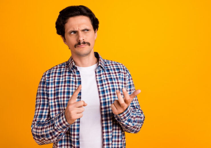 Photo of handsome unsure young guy fingers count math problem look empty space wear trendy plaid look isolated on yellow color background