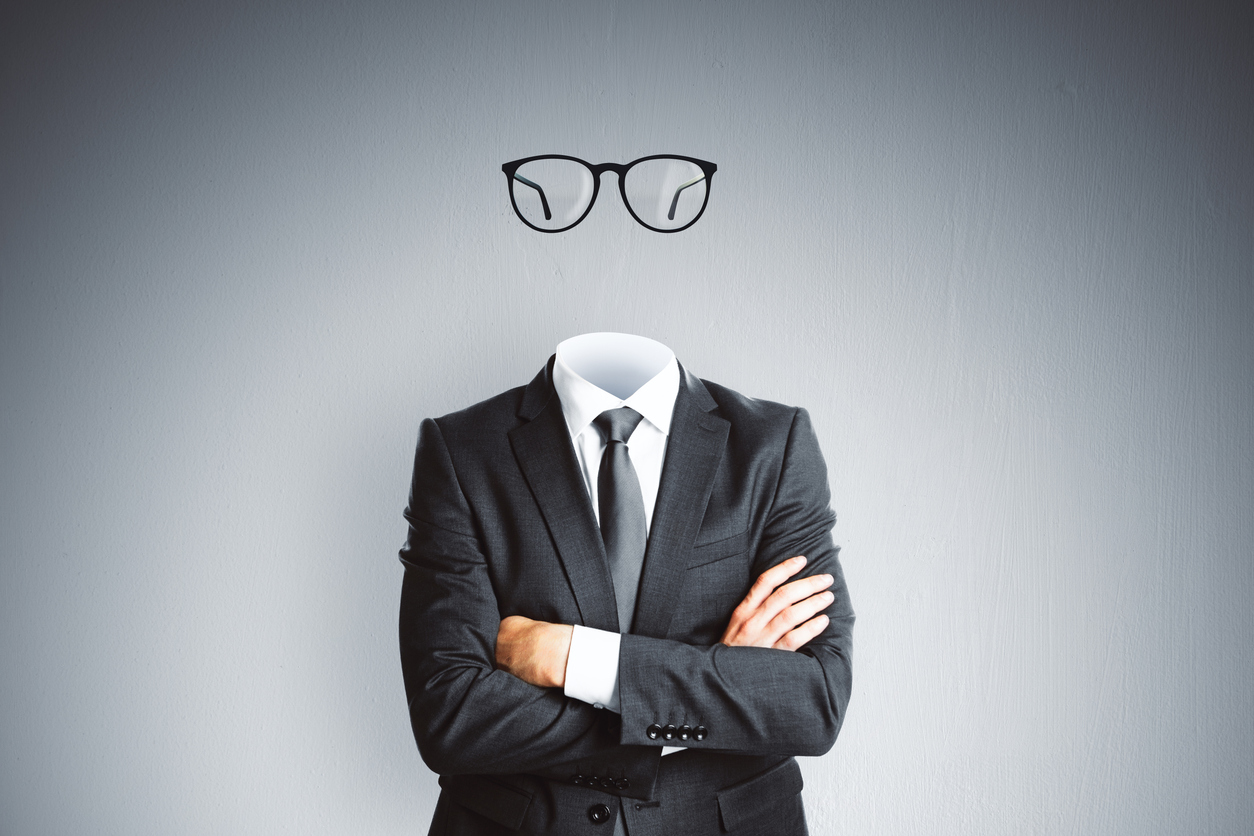 Headless invisible businessman in suit with folded arms and abstract glasses standing on gray wall background. Business and secret concept.