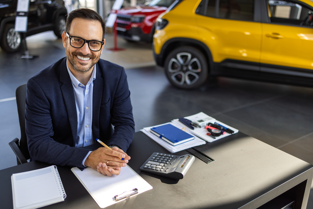 The careful attention a man gives to paperwork in the car showroom crafts clarity in every contract, ensuring that each customer leaves with confidence and a new set of keys