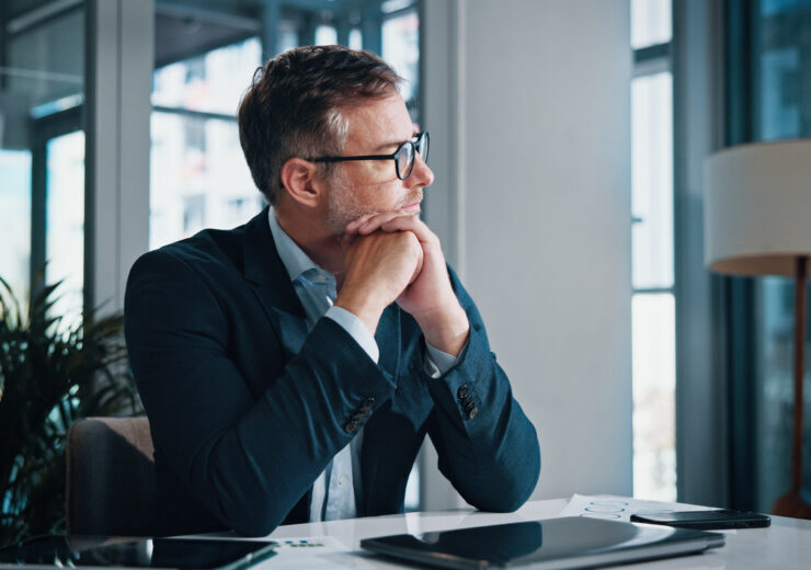 Business, thinking and man in office, solution and decision for career growth, doubt and problem solving. Person, employee and consultant in workplace, laptop and planning with choice and options
