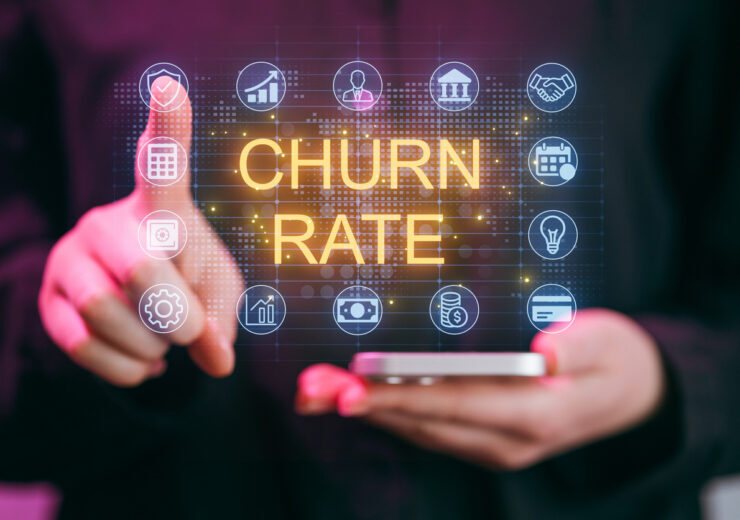 Focus on churn rate analysis through digital dashboard with user interaction in modern office setting