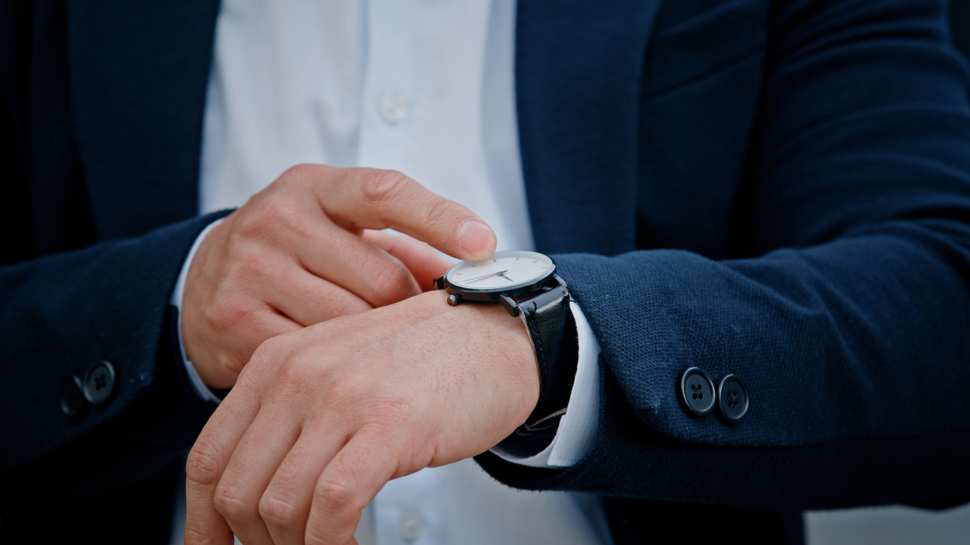 Cropped view closeup male hand with wristwatch clock Asian middle-aged businessman manager man male boss company CEO entrepreneur employer check time lateness waiting for meeting taxi in city outdoors