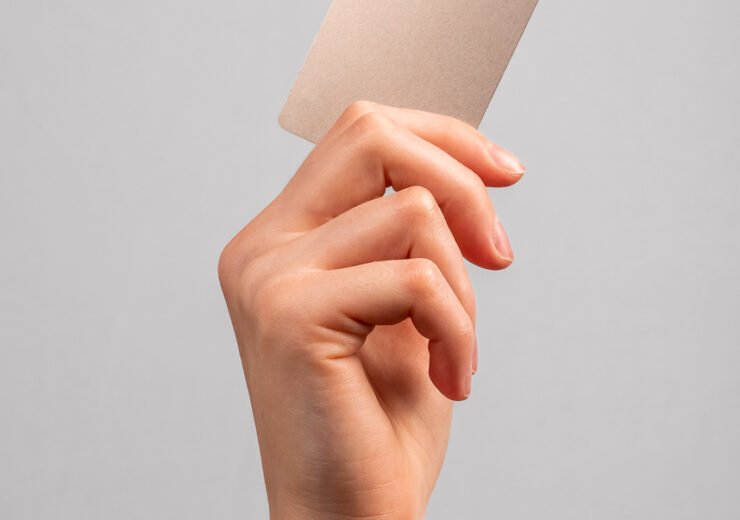 Hand holding credit card mockup with chip. Buying at stores, making transactions at terminals. Secure payments